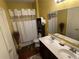 Bathroom with double vanity, shower/tub and dark wood cabinets at 1427 Pacific Rd, Kissimmee, FL 34759
