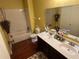 Clean bathroom with double vanity, tub, and toilet at 1427 Pacific Rd, Kissimmee, FL 34759
