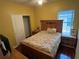 Bedroom with wood-framed bed and neutral decor at 1427 Pacific Rd, Kissimmee, FL 34759