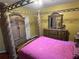 Main bedroom with a canopy bed and matching dresser set at 1427 Pacific Rd, Kissimmee, FL 34759