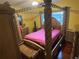 Main bedroom with a canopy bed and matching furniture set at 1427 Pacific Rd, Kissimmee, FL 34759