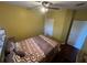 Spacious bedroom with a queen-size bed and wood floors at 1427 Pacific Rd, Kissimmee, FL 34759