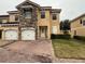 Two-story townhome with two-car garage and brick paved driveway at 1427 Pacific Rd, Kissimmee, FL 34759