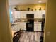 Modern kitchen with white cabinets and black appliances at 1427 Pacific Rd, Kissimmee, FL 34759