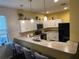 Modern kitchen with white cabinets, granite counters and breakfast bar at 1427 Pacific Rd, Kissimmee, FL 34759