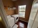 Laundry room with washer, dryer, and shelving at 1427 Pacific Rd, Kissimmee, FL 34759