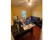 Living room with black leather couches and a home office space at 1427 Pacific Rd, Kissimmee, FL 34759
