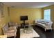 Living room with sofa, chairs, and coffee table at 1427 Pacific Rd, Kissimmee, FL 34759