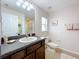 Bathroom with single sink vanity, toilet, and linen storage at 154 Robin Rd, Davenport, FL 33896