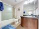 Bathroom with tub, shower, and wood vanity at 154 Robin Rd, Davenport, FL 33896