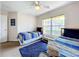 Bedroom with two twin beds, blue bedding, and ceiling fan at 154 Robin Rd, Davenport, FL 33896