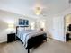 Serene bedroom with ceiling fan, dresser, and ensuite bathroom access at 154 Robin Rd, Davenport, FL 33896