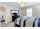 Comfortable bedroom with ceiling fan and striped bedding at 154 Robin Rd, Davenport, FL 33896