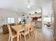 Spacious dining area with a large wooden table and six chairs at 154 Robin Rd, Davenport, FL 33896