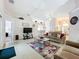 Spacious living room with vaulted ceiling and a large area rug at 154 Robin Rd, Davenport, FL 33896