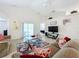 Comfortable living room featuring a cozy seating area and large TV at 154 Robin Rd, Davenport, FL 33896