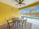 Relaxing patio area with table and chairs overlooking a refreshing pool at 154 Robin Rd, Davenport, FL 33896