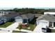 Three new homes with gray roofs and blue siding, and landscaped yards at 1657 Rosydale Cir, Davenport, FL 33837