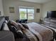 Bright bedroom with a comfortable bed and workspace at 1657 Rosydale Cir, Davenport, FL 33837