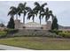Charles Cove community entrance with stonework, fountain, and palm trees at 1657 Rosydale Cir, Davenport, FL 33837