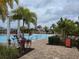 Resort-style pool with palm trees and lounge chairs at 1657 Rosydale Cir, Davenport, FL 33837