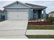 Newly built home with a two-car garage and landscaped yard at 1657 Rosydale Cir, Davenport, FL 33837