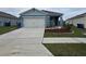 Two-car garage and well maintained landscaping at 1657 Rosydale Cir, Davenport, FL 33837
