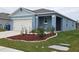 Curb appeal with a two-car garage and front porch at 1657 Rosydale Cir, Davenport, FL 33837