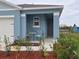 Small front porch with bistro table and chairs at 1657 Rosydale Cir, Davenport, FL 33837