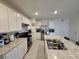 Bright kitchen featuring white cabinets and an island at 1657 Rosydale Cir, Davenport, FL 33837