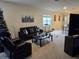 Living room with sofa, chair, coffee table, and a Christmas tree at 1657 Rosydale Cir, Davenport, FL 33837