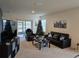 Living room with sofa, chair, coffee table, and a Christmas tree at 1657 Rosydale Cir, Davenport, FL 33837