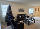 Living room with sofa, chair, coffee table, and a Christmas tree at 1657 Rosydale Cir, Davenport, FL 33837