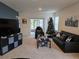 Living room with sofa, chair, coffee table, and a Christmas tree at 1657 Rosydale Cir, Davenport, FL 33837