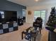 Spacious living room with large TV, comfortable seating, and a cozy Christmas tree at 1657 Rosydale Cir, Davenport, FL 33837