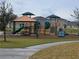 Modern playground with slides, climbing structures, and picnic tables at 1657 Rosydale Cir, Davenport, FL 33837