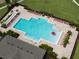 Community pool with plenty of lounge chairs and a pergola at 1657 Rosydale Cir, Davenport, FL 33837