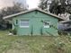 Newly painted green house with well-manicured lawn at 1808 S Mulberry Ave, Sanford, FL 32771