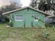 Newly painted green house with well-manicured lawn at 1808 S Mulberry Ave, Sanford, FL 32771