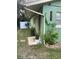 Green house exterior with a walkway and landscaping at 1808 S Mulberry Ave, Sanford, FL 32771