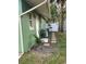 Side yard with green house exterior, landscaping, and walkway at 1808 S Mulberry Ave, Sanford, FL 32771