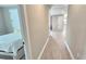 Bright hallway with wood-look floors and access to bedrooms at 2016 Keystone Pass Blvd, Minneola, FL 34715