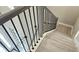 Modern staircase with simple metal railing and light wood treads at 2016 Keystone Pass Blvd, Minneola, FL 34715