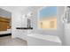 Modern bathroom with soaking tub and double vanity at 2137 Pine Oak Loop, Davenport, FL 33837