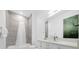 Clean bathroom with a shower/tub combo, white vanity, and gray tile at 2137 Pine Oak Loop, Davenport, FL 33837