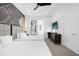 Bright bedroom featuring two beds, a TV, and a small workspace at 2137 Pine Oak Loop, Davenport, FL 33837