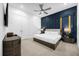 Elegant bedroom with a king-size bed, dark wood furniture, and a navy accent wall at 2137 Pine Oak Loop, Davenport, FL 33837