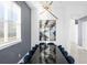 Modern dining room with dark wood table and blue chairs at 2137 Pine Oak Loop, Davenport, FL 33837