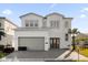 Two-story home with gray roof, double doors, and landscaped lawn at 2137 Pine Oak Loop, Davenport, FL 33837