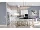 Modern kitchen with white cabinets, black countertops, and gold barstools at 2137 Pine Oak Loop, Davenport, FL 33837